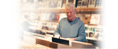 Erbitux patient smiling and looking through vinyl records at store
