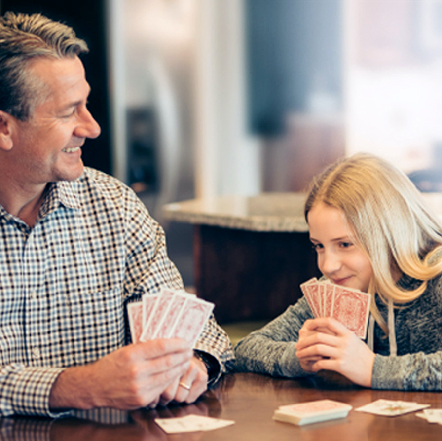 father and daughter playing cards